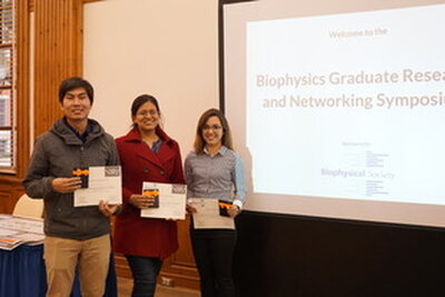 Graduate students in front of a projected screen