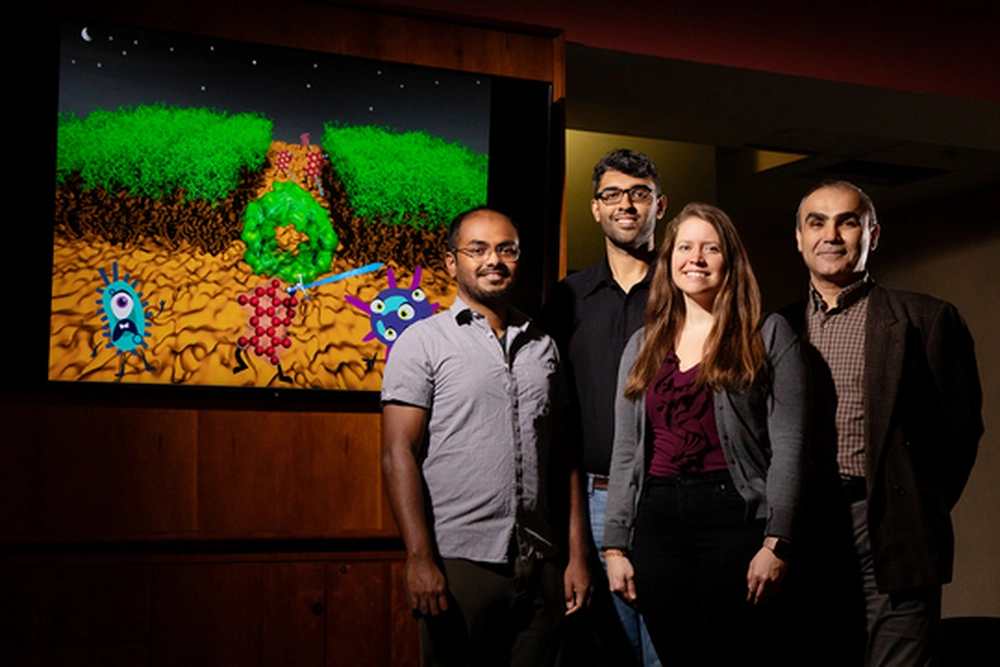 Scientists standing behind a cartoon