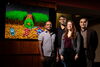 Scientists standing behind a cartoon